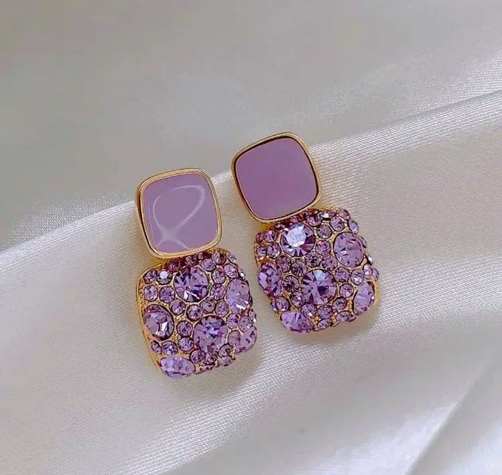 Square lavender earrings with crystal embellishments and a gold setting.