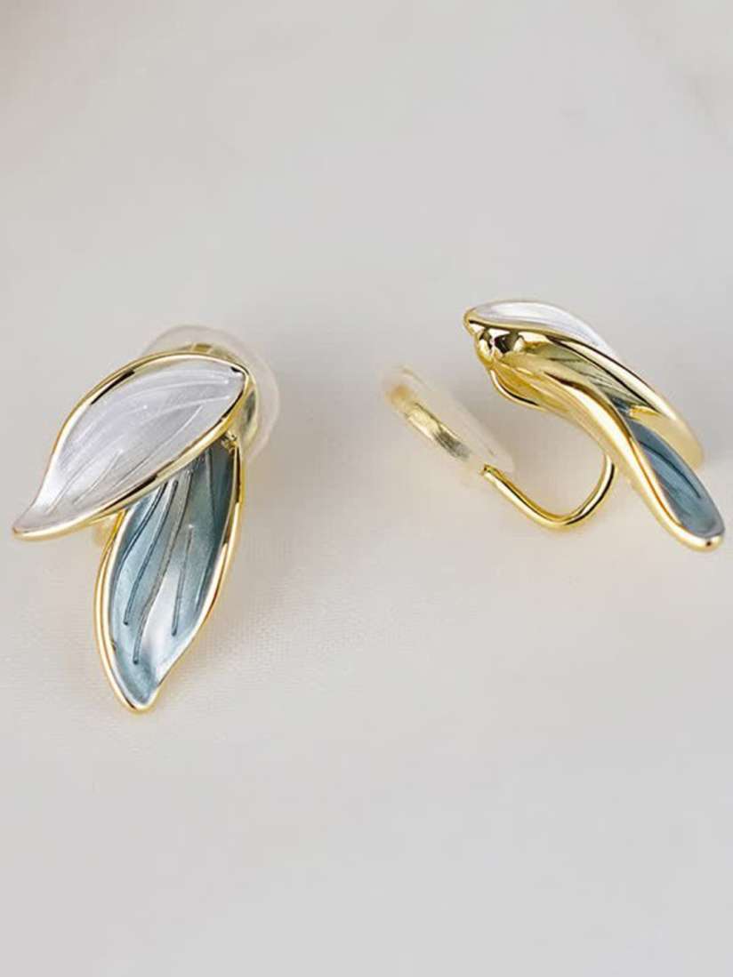 Leaf-shaped clip earrings with white and blue enamel and gold-tone finish.