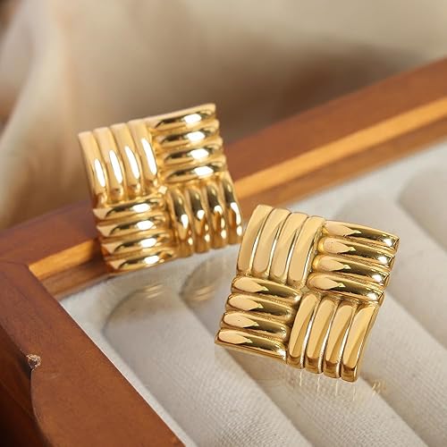 Close-up of square gold earrings with a woven design.