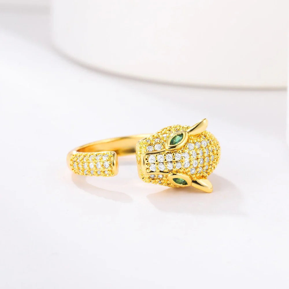 Gold panther ring with green gemstone eyes and pave setting.