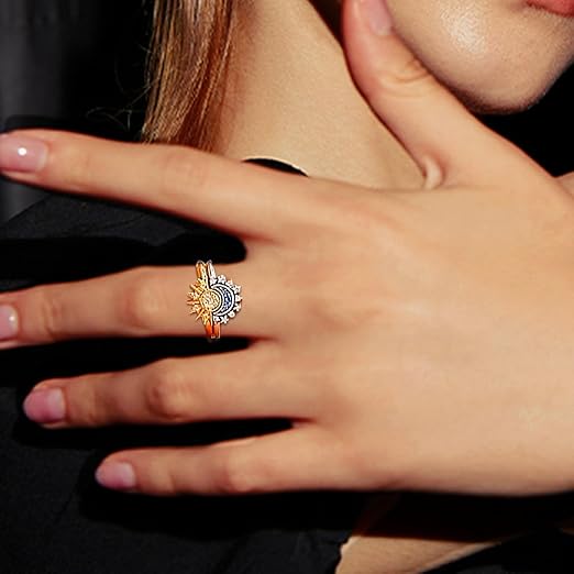 Close up of a woman's hand wearing a sun and moon ring.