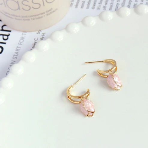 Gold hoop earrings with pink tulip charms.