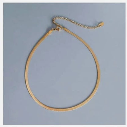 Gold herringbone chain necklace with adjustable clasp.