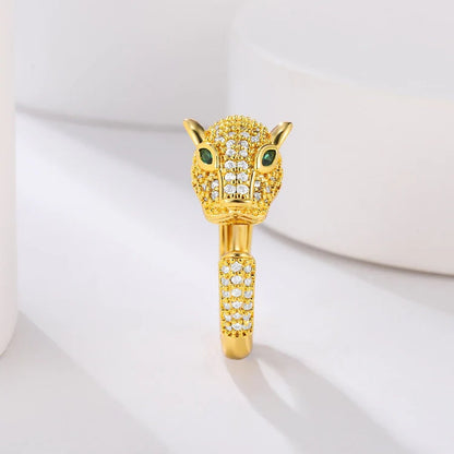 Gold tiger ring with green eyes and crystal accents.
