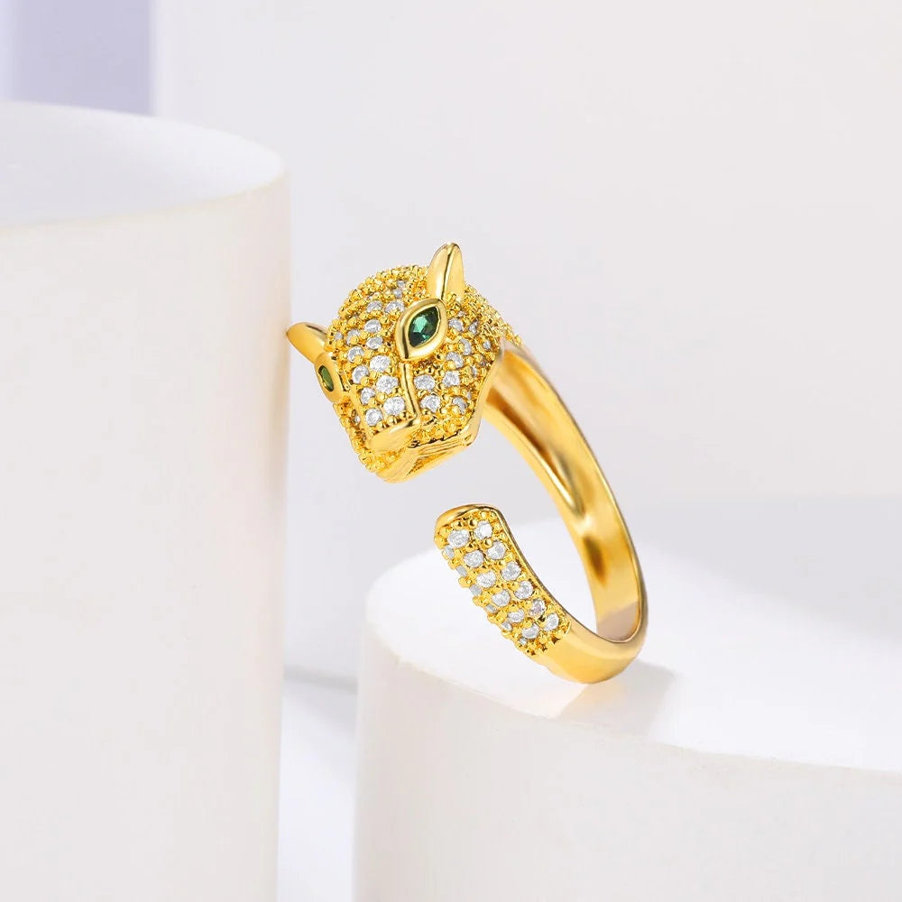 Gold-tone ring featuring a jaguar head design with green eyes and crystal accents.