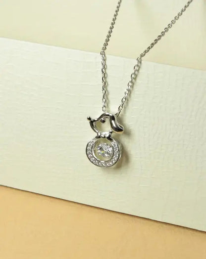 Silver-tone dog pendant necklace with round crystal halo and center stone.