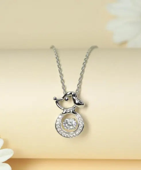 Silver-toned girl pendant necklace with round cubic zirconia stones.